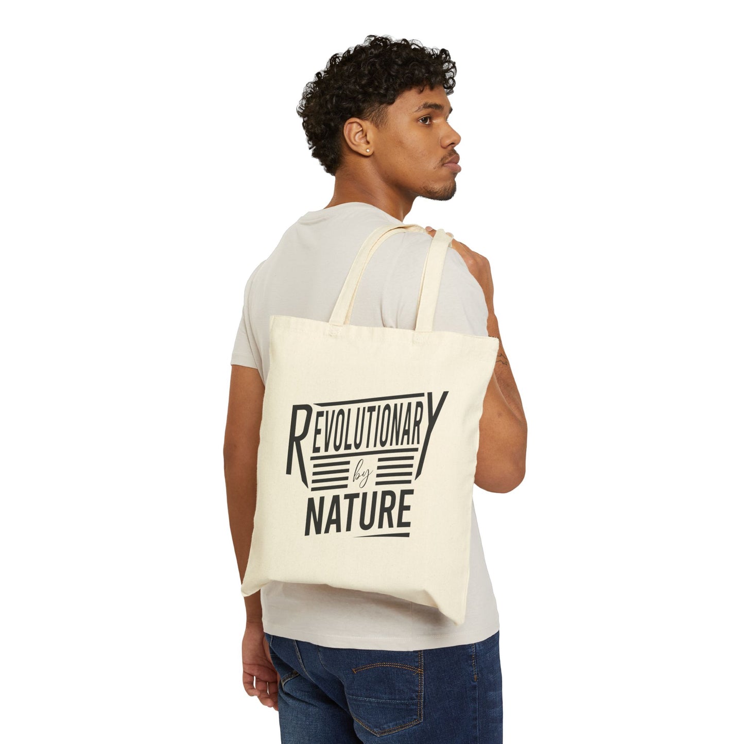 Man wearing a Revolutionary by Nature tote bag by Printify in beige canvas with black text design