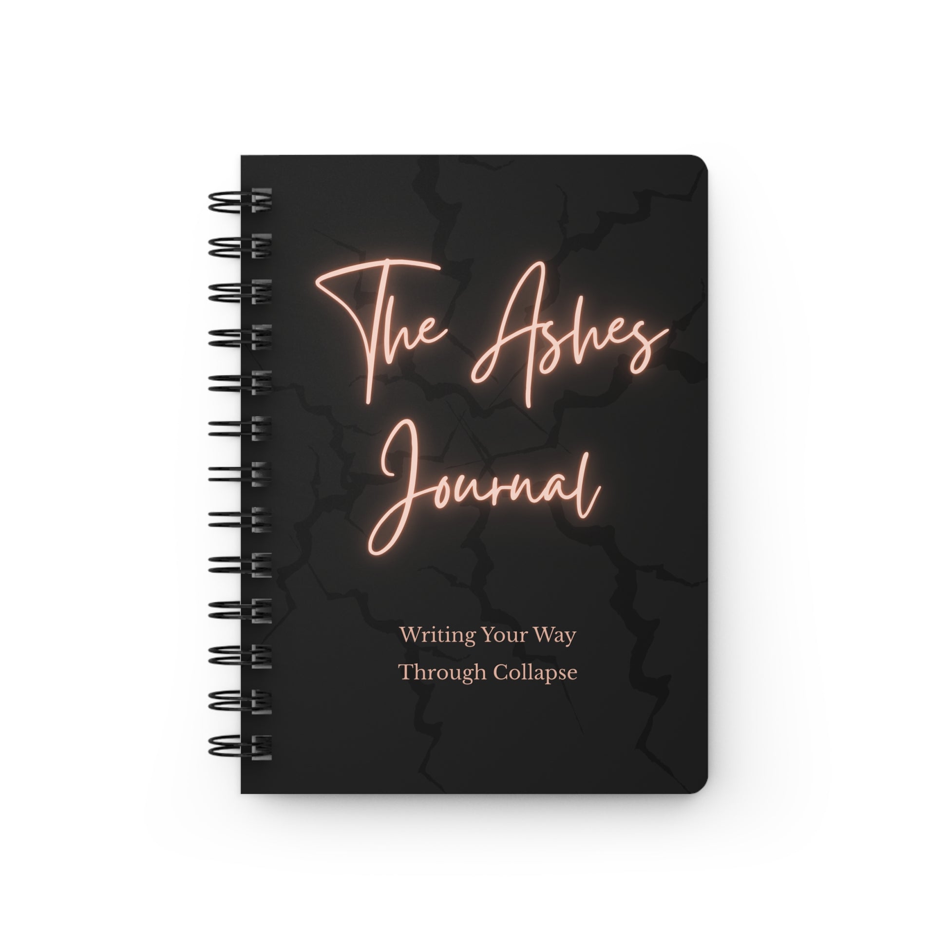 The Ashes Journal spiral notebook as a transformational journaling guide with black cover and neon text